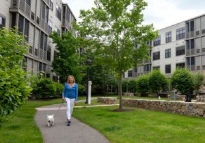 senior woman walking her dog at waterstone at wellesley