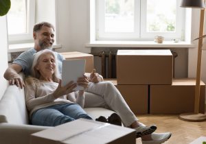 Senior couple using digital tablet buying goods for new home